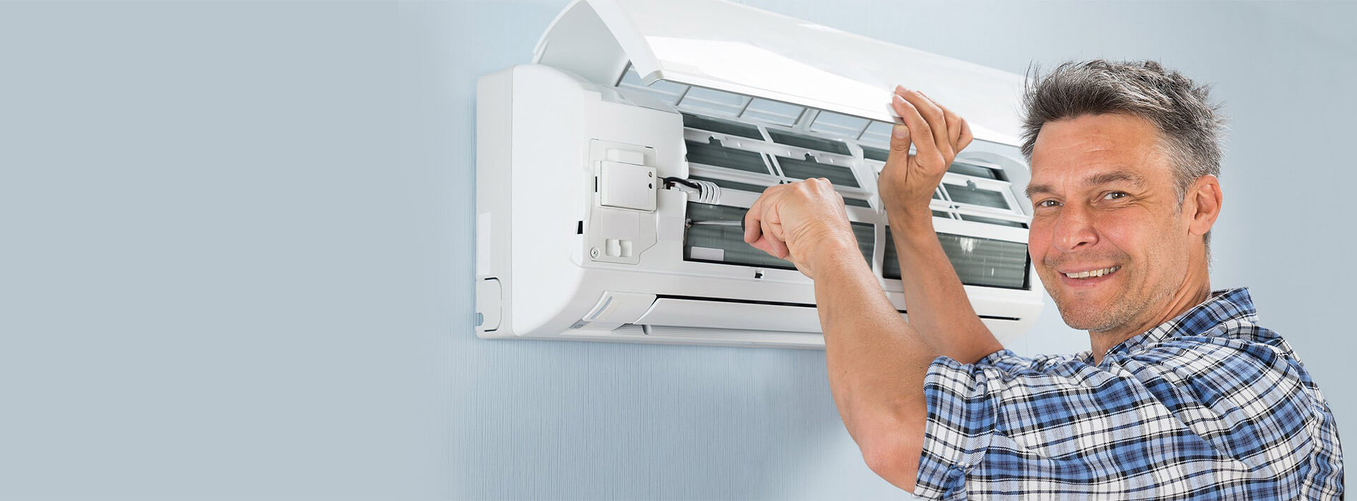 Technician measuring room for correct AC size